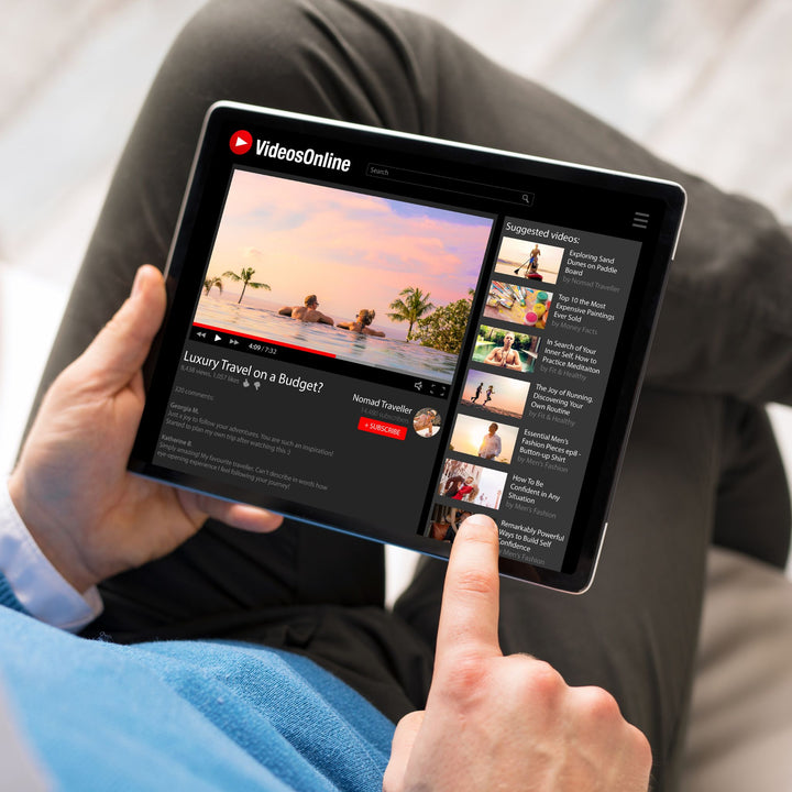 Person holding tablet editing video, representing social media video content creation and consultation by JFK Løvlien